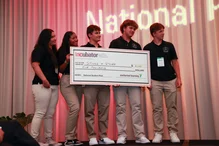 Photo of Sticks & Stones receiving their winning investment check for $5,000